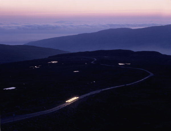 Evening light with distant car on road